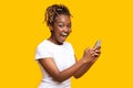 Excited black woman using mobile phone, got new nice app