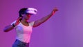 Excited Black Woman Wearing VR Headset Experiencing Virtual Reality In Neon Light Royalty Free Stock Photo