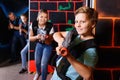 Excited boy aiming laser gun at other players during laser tag g Royalty Free Stock Photo