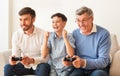 Excited Boy, Father And Grandpa Playing Video Games At Home Royalty Free Stock Photo