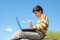 Excited boy playing with wireless laptop