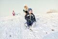 Excited little boy on snow tobogganing Royalty Free Stock Photo