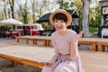 Excited brunette girl in trendy hat received message from friend and laughing. Portrait of joyful young woman in vintage Royalty Free Stock Photo