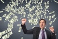 Excited business man with money rain against blue background Royalty Free Stock Photo