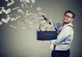 Excited business man opening a box letting dollar banknotes to fly away Royalty Free Stock Photo