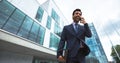 Excited business man talking on the phone against building background Royalty Free Stock Photo