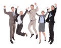 Excited business people jumping over white background