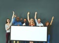 Excited business people showing a blank sign, promoting a product and giving a message on a board while standing