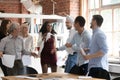 Excited business team people dancing holding papers celebrate successful contract Royalty Free Stock Photo
