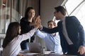 Excited business team uniting palms together on briefing in office Royalty Free Stock Photo