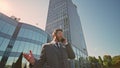 Excited businessman calling phone on sunny street close up. Happy manager talk Royalty Free Stock Photo