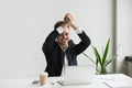 Excited businessman celebrating online lottery win Royalty Free Stock Photo