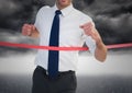 Excited businessman crossing the finish line Royalty Free Stock Photo