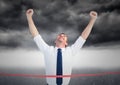 Excited businessman crossing the finish line Royalty Free Stock Photo