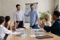 Excited businessman introduce male newcomer at office meeting