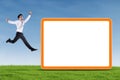 Excited businessman jumping with blank board Royalty Free Stock Photo