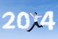 Excited businessman jumping with 2014 Royalty Free Stock Photo