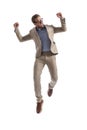 Excited businessman jumping and raising his arms in the air Royalty Free Stock Photo