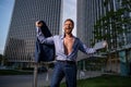 Excited businessman model in unbuttoned shirt outdoor office city. Ambitions concept and success business.