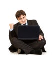 Excited businessman sitting on floor with laptop Royalty Free Stock Photo