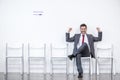 Excited businessman sitting and waiting for interview in office Royalty Free Stock Photo