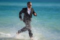Excited businessman in wet suit run in sea. Funny business man, crazy comic business concept. Remote online working Royalty Free Stock Photo