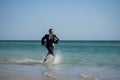 Excited businessman in wet suit run in sea. Funny business man, crazy comic business concept. Remote online working Royalty Free Stock Photo