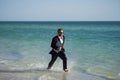 Excited businessman in wet suit run in sea. Funny business man, crazy comic business concept. Remote online working