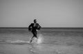 Excited businessman in wet suit run in sea. Funny business man, crazy comic business concept. Remote online working