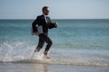 Excited businessman in wet suit run in sea. Funny business man, crazy comic business concept. Remote online working