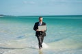 Excited businessman in wet suit run in sea. Funny business man, crazy comic business concept. Remote online working