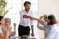 Excited businessmen fist bumping at meeting celebrating corporate teamwork success Royalty Free Stock Photo