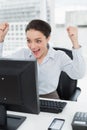 Excited businesswoman looks at the computer screen in office Royalty Free Stock Photo