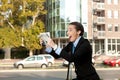 Excited businesswoman with newspaper