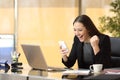 Excited businesswoman reading a smart phone