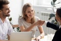 Excited businesswoman shaking hand of business partner at successful meeting Royalty Free Stock Photo