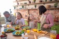 Excited Caucasian family parents and two kids girls happy playing rock paper scissors before start to cook the dinner