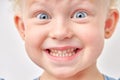 excited caucasian kid girl has broad smile, shows perfect teeth over white studio background. Royalty Free Stock Photo