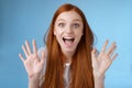 Excited charismatic happy lively redhead young funny woman smiling thrilled open mouth fascinated wide eyes surprised Royalty Free Stock Photo