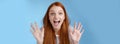 Excited charismatic happy lively redhead young funny woman smiling thrilled open mouth fascinated wide eyes surprised Royalty Free Stock Photo