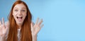 Excited charismatic happy lively redhead young funny woman smiling thrilled open mouth fascinated wide eyes surprised Royalty Free Stock Photo