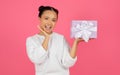 Excited Cheerful Asian Female Holding Wrapped Present Box On Her Palm Royalty Free Stock Photo