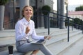 Excited cheerful business woman achieves its goals working with laptop outdoor Royalty Free Stock Photo