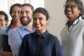 Excited cheerful diverse team of department employees standing together Royalty Free Stock Photo