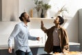 Excited cheerful hipster Black couple enjoying home party in kitchen Royalty Free Stock Photo