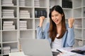 Excited Asian businesswoman celebrating and rejoicing her career success Royalty Free Stock Photo