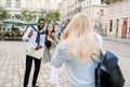 Excited cheerful mix raced couple, African man and Caucasian girl, enjoying walking outdoors, in the center of ancient Royalty Free Stock Photo