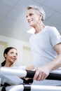 Excited cheerful pensioner smiling while being in a good gym