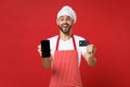 Excited chef cook or baker man in striped apron t-shirt toque chefs hat isolated on red background. Cooking food concept Royalty Free Stock Photo