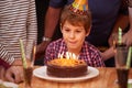Excited, child and candles on birthday cake at party in celebration and hungry for food on table. Happy, kid and family Royalty Free Stock Photo
